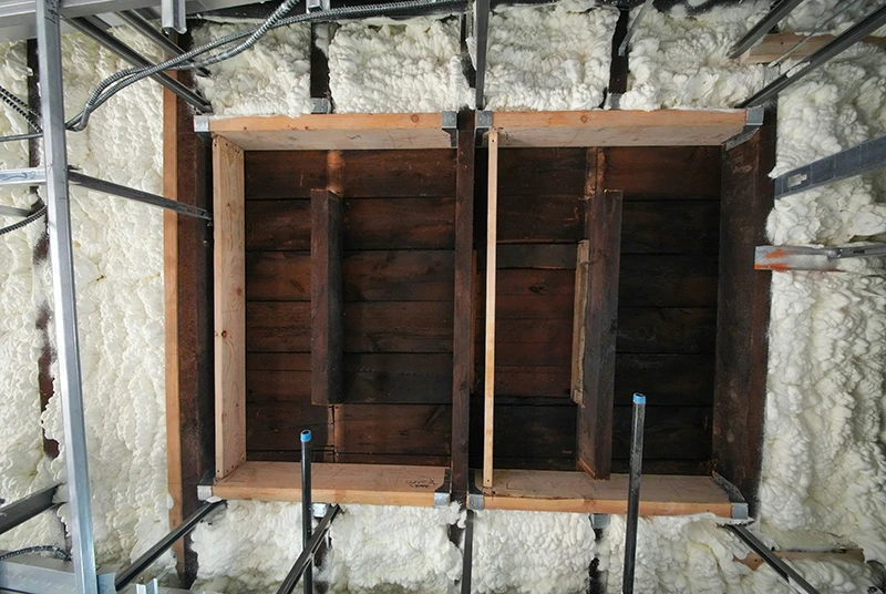 Training wall section showing timber framing, insulation material and service cavities used for SVQ insulation and building treatments practical training.